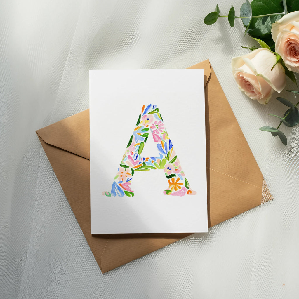 Card with a large letter A in floral pattern on an envelope.