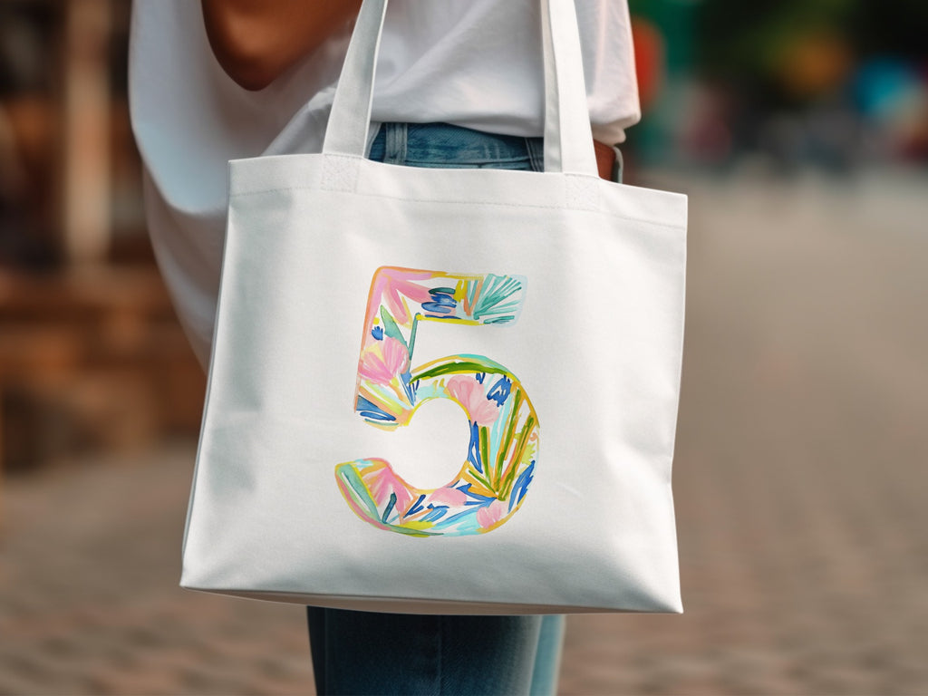 White tote bag with a colorful watercolor number 5 design.