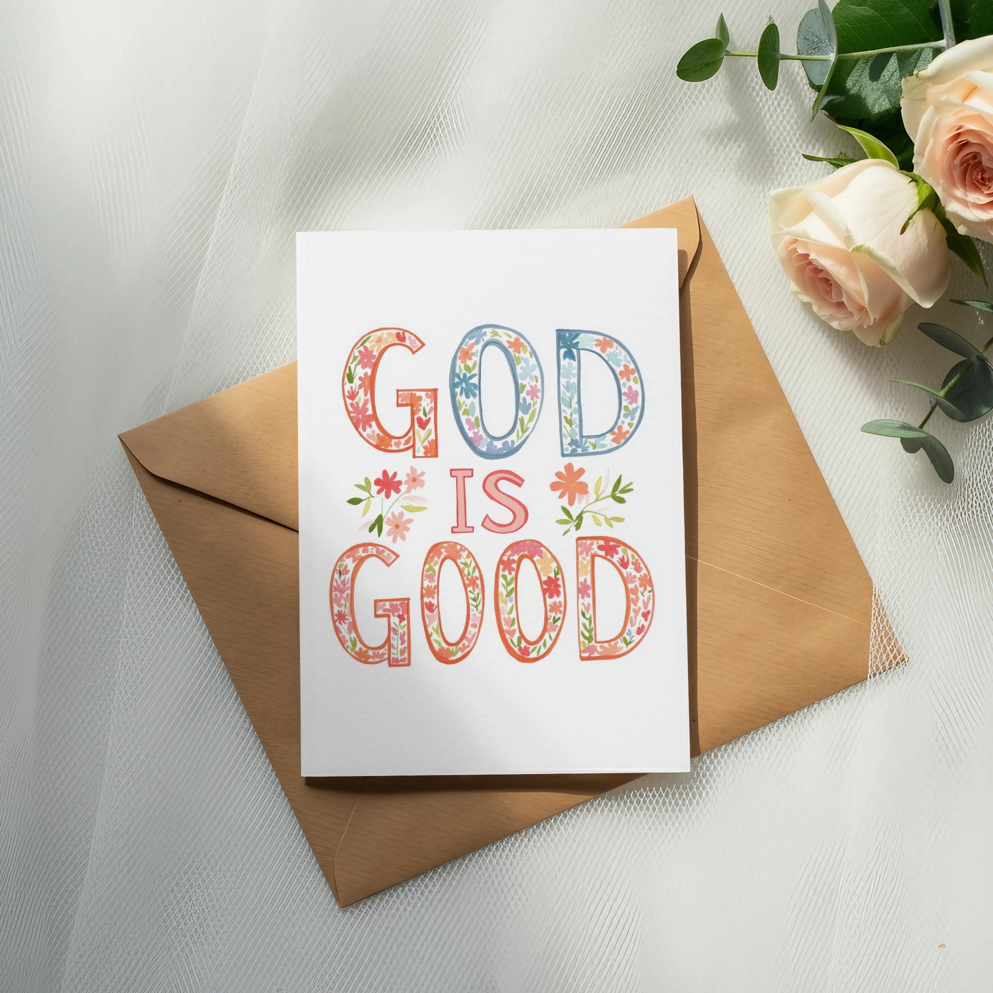 Greeting card with "God Is Good" text in colorful floral lettering.