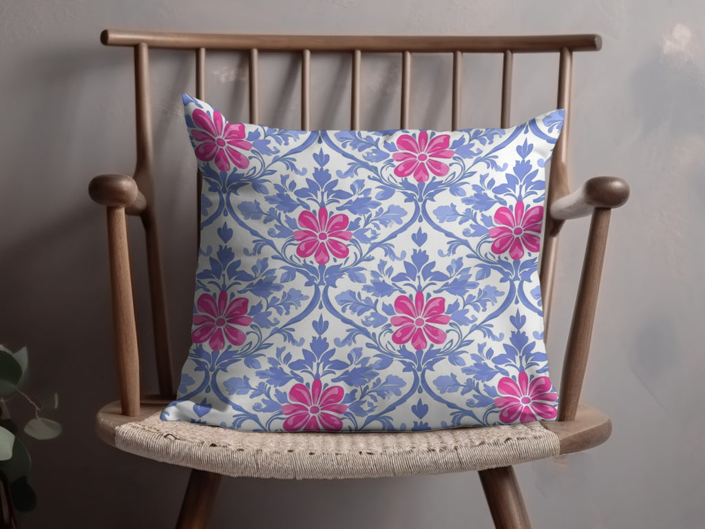 Throw pillow with a blue floral pattern on a wooden chair.