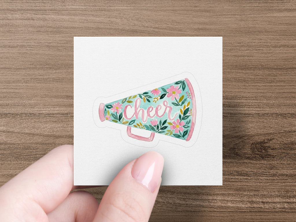 Pink megaphone with floral design and the word "Cheer".