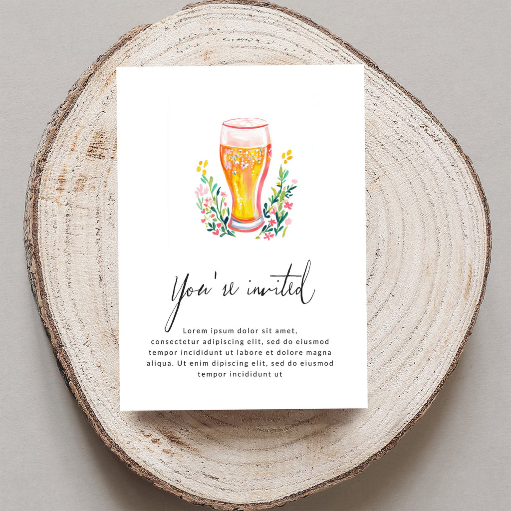 Invitation card with "You're invited" and floral design, on a wooden slice.