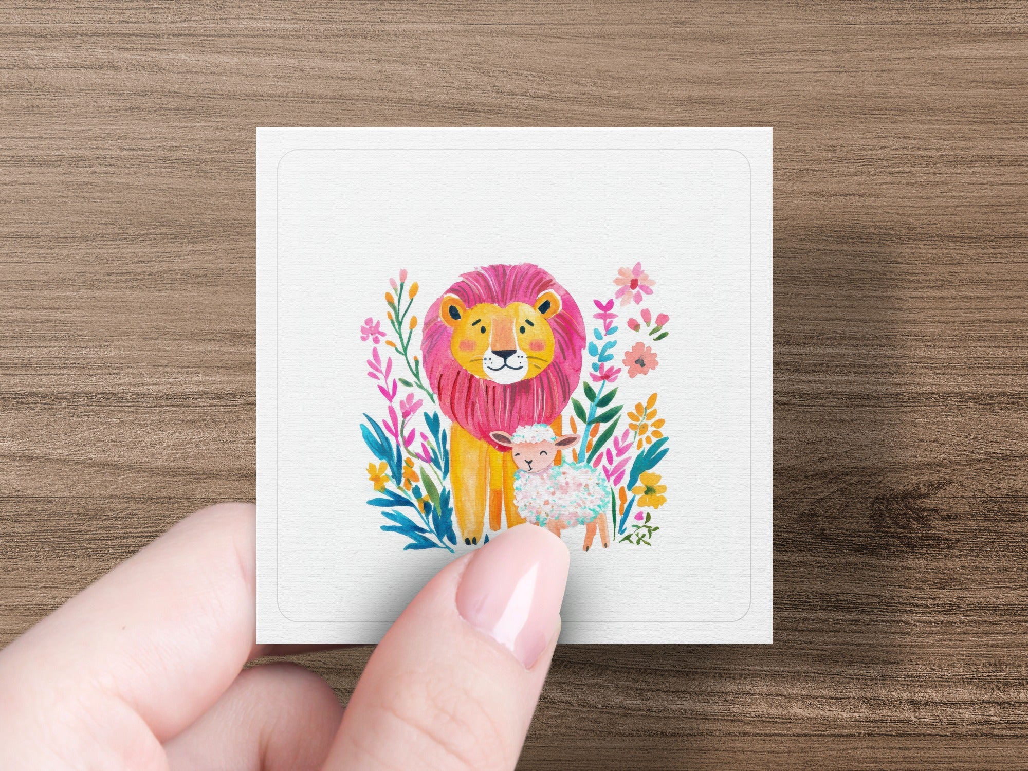 Watercolor illustration of a lion and lamb surrounded by colorful flowers.