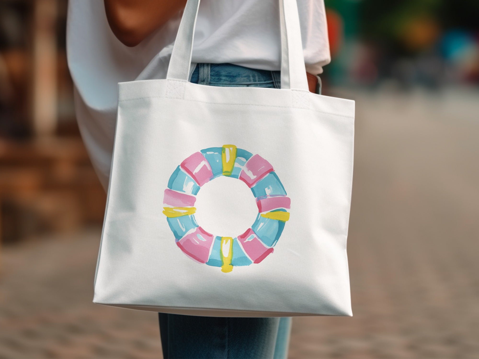 White tote bag with a colorful, circular life preserver design.