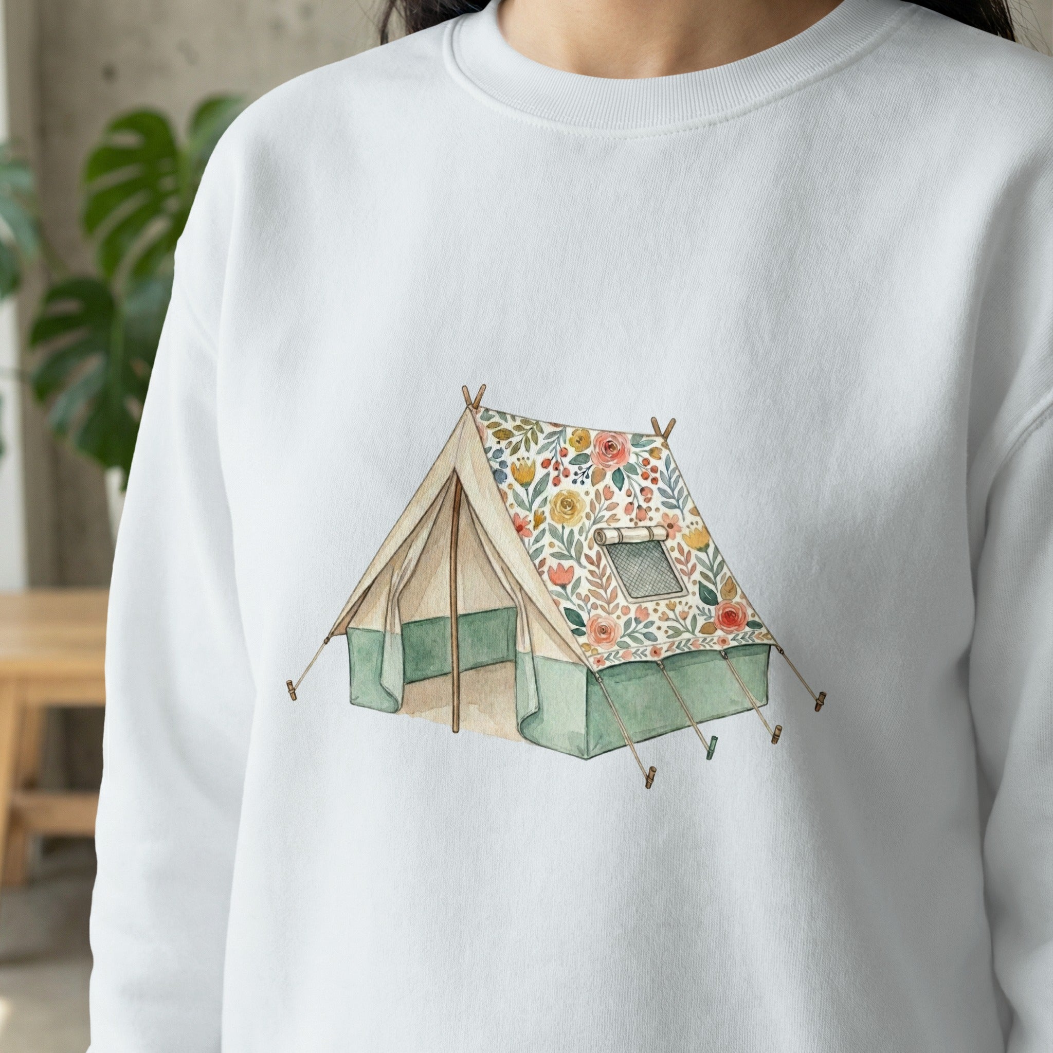 Watercolor tent with floral pattern on a white sweatshirt.