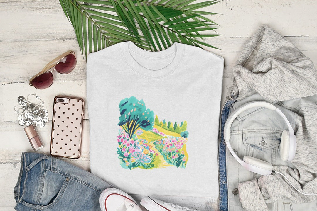 White t-shirt with colorful floral garden illustration, sunglasses, headphones, and jeans.