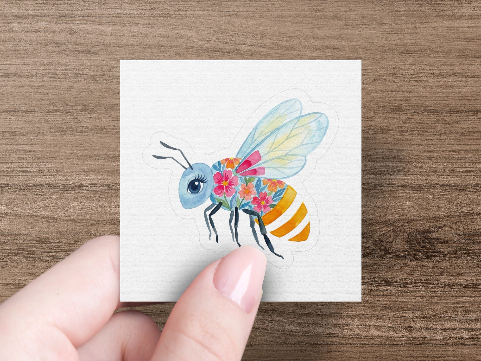 Cute bee sticker with floral body and colorful wings.