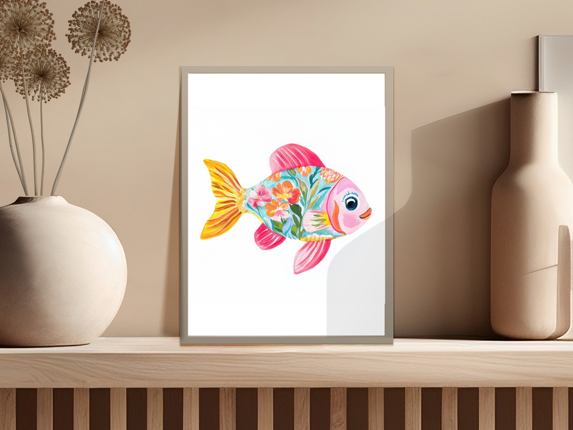 Colorful, floral-patterned fish illustration in a framed print on a shelf.