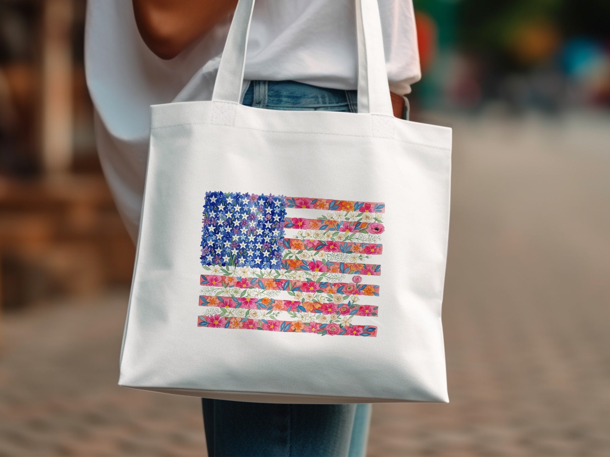 White tote bag with a floral American flag design.