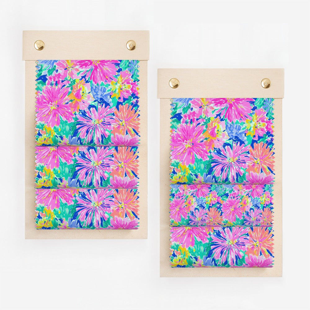 Two fabric swatches with bright pink and blue floral patterns.