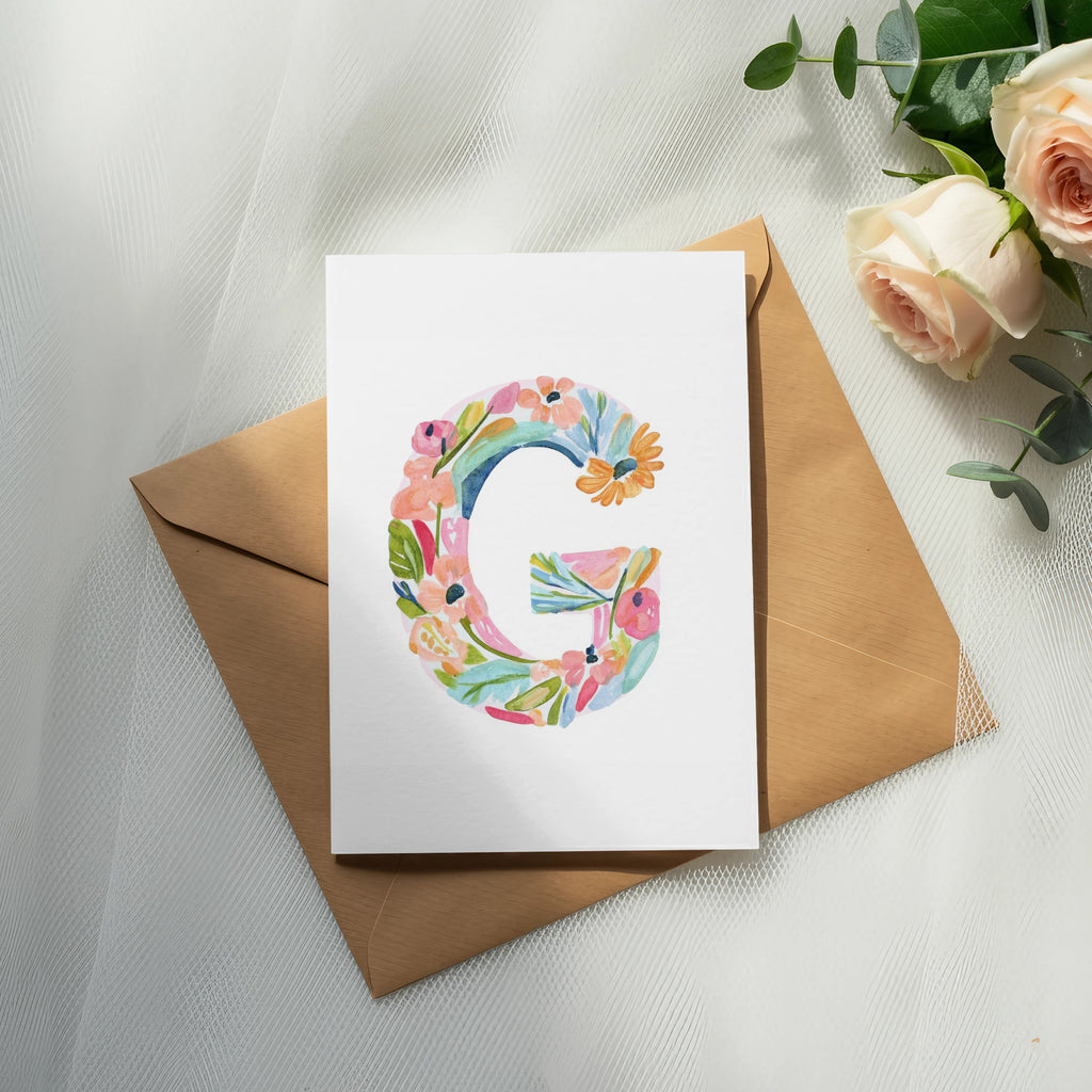 Card with watercolor letter G on an envelope, with roses.