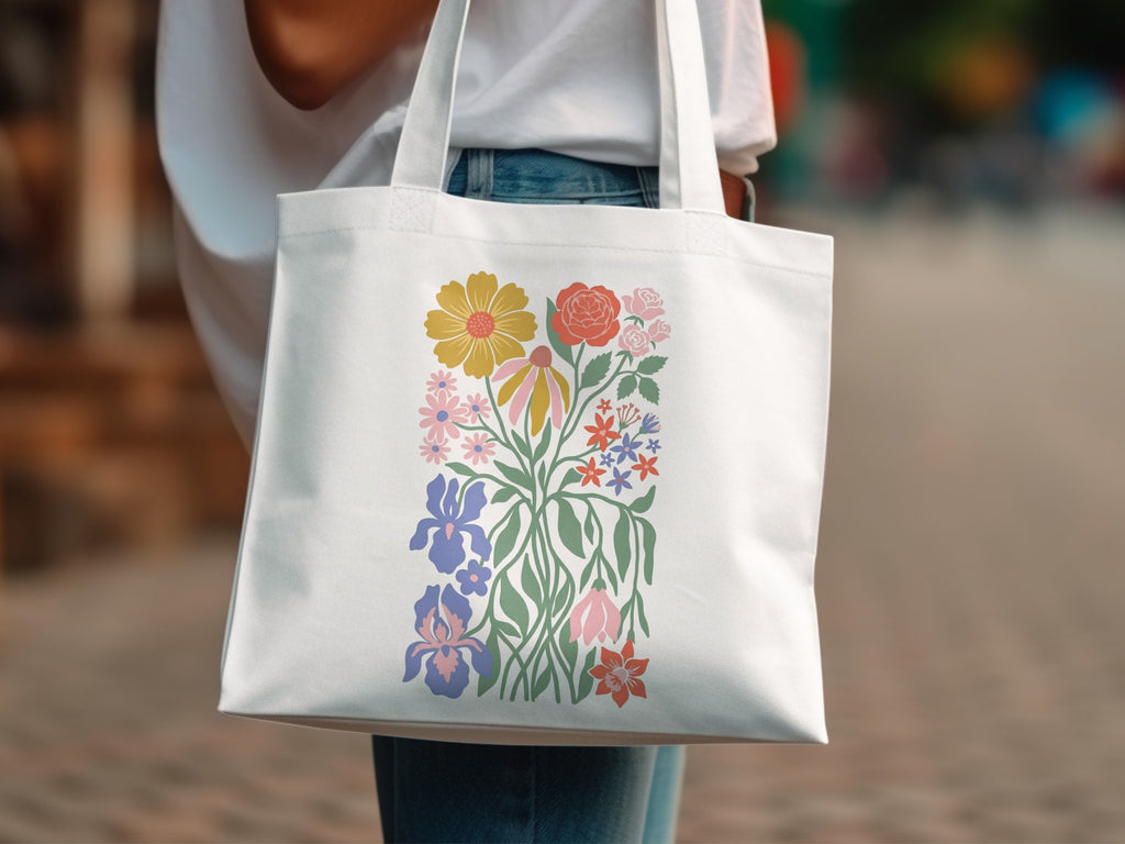 White tote bag with a colorful floral illustration.