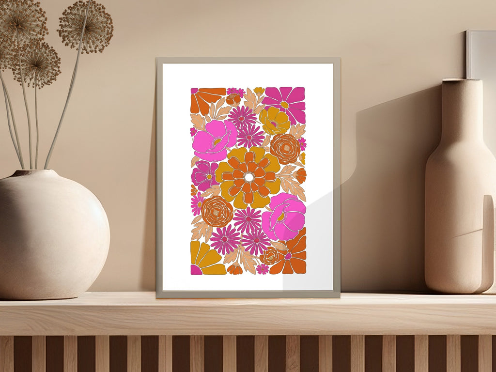 Retro floral art print in a silver frame with pink and orange flowers.