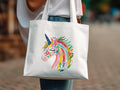 White tote bag with colorful floral unicorn head design.