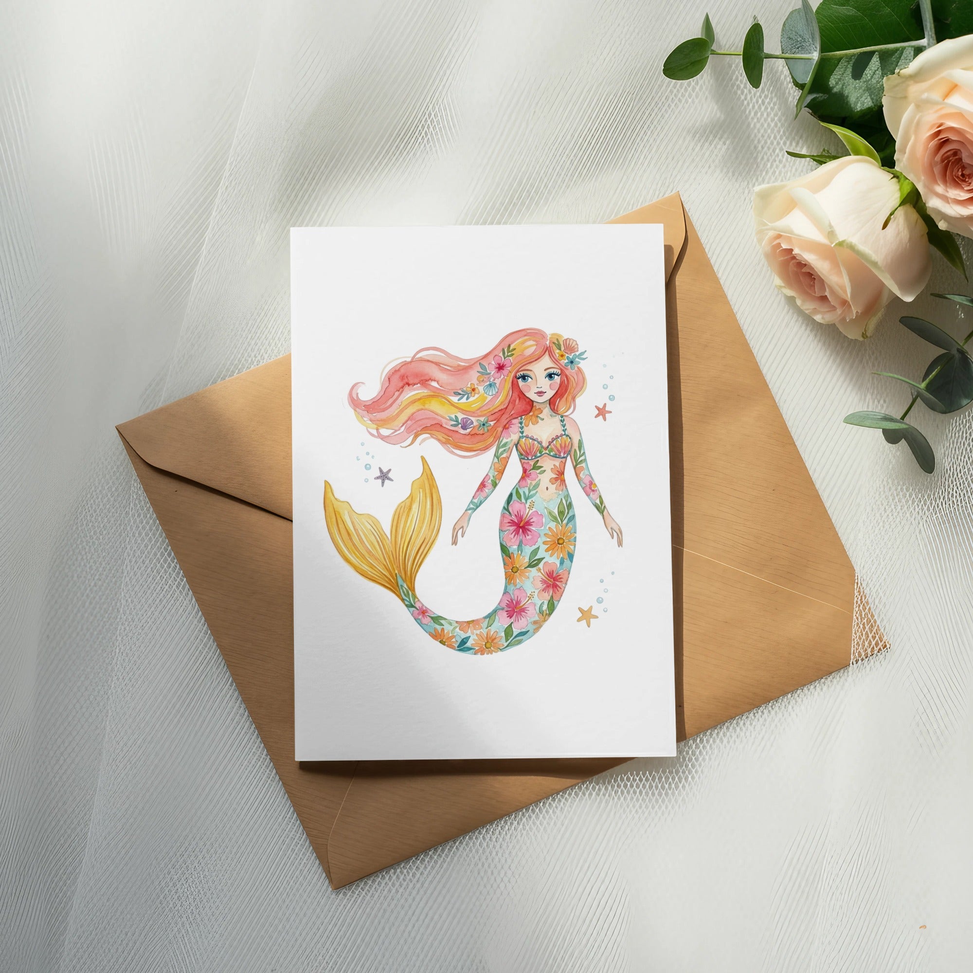 Watercolor mermaid with floral pattern on white card, on brown envelope.