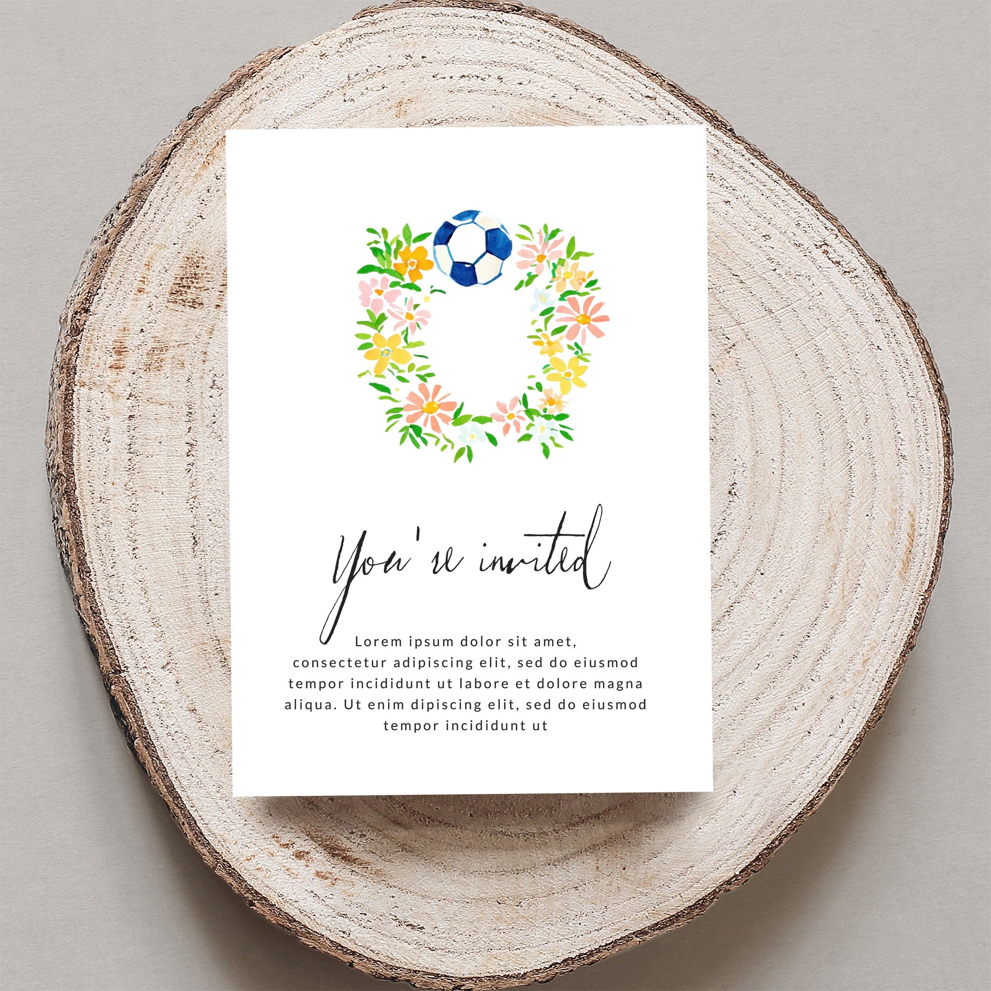 Floral soccer wreath invitation with "You're invited" text.