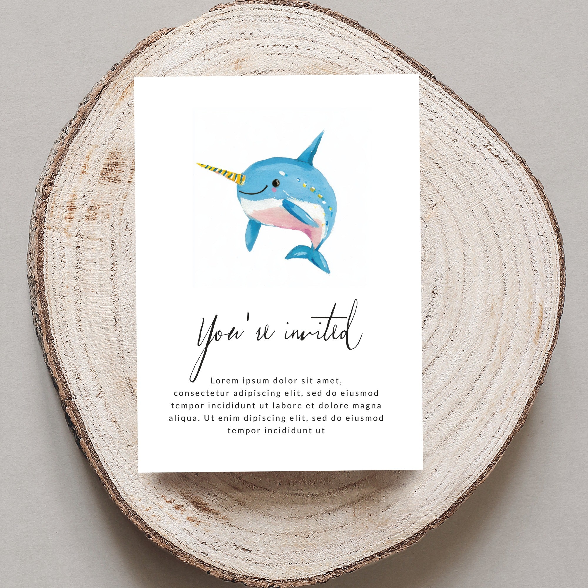 Invitation with a cartoon narwhal and "You're invited" text.