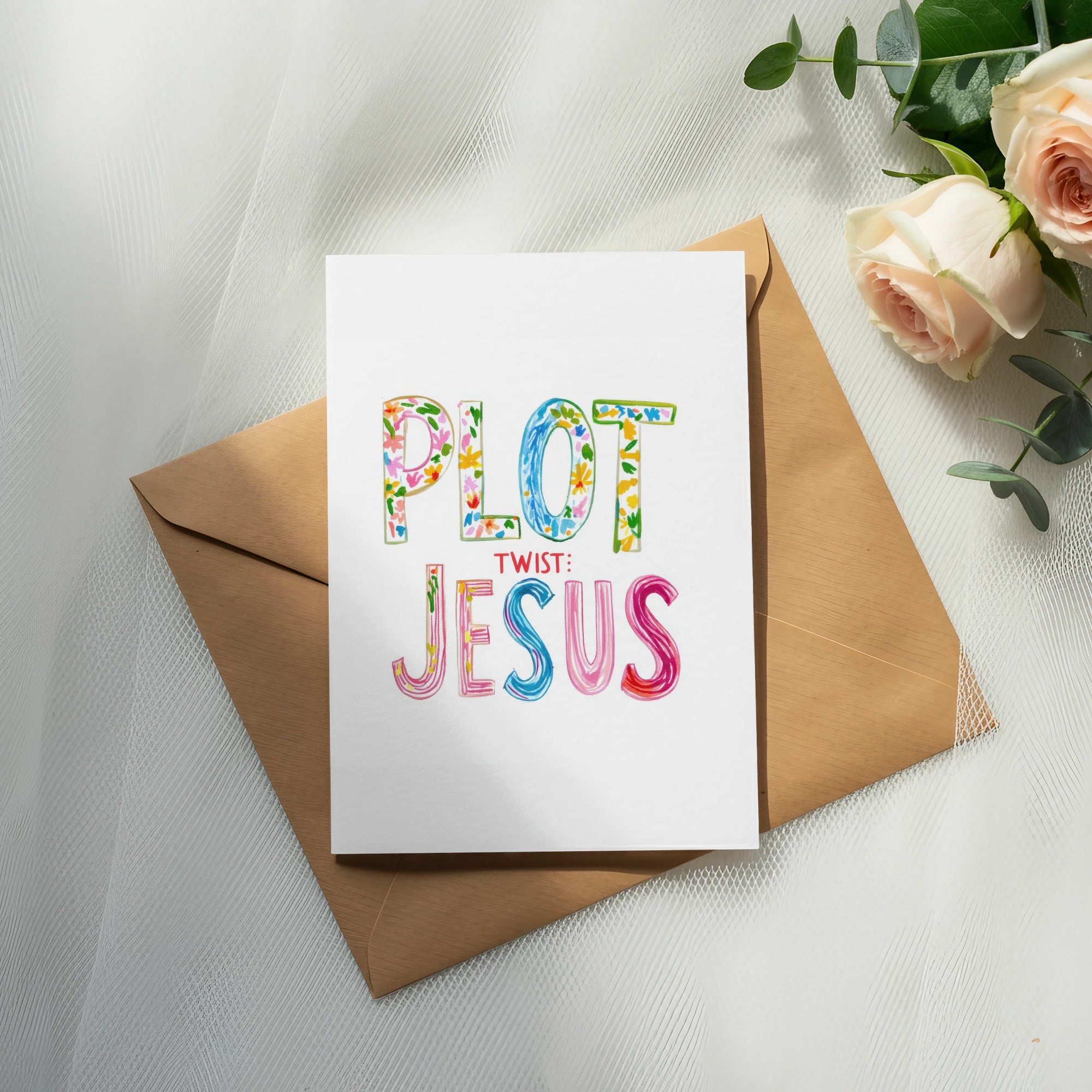 Greeting card with colorful "PLOT TWIST: JESUS" text on brown envelope.