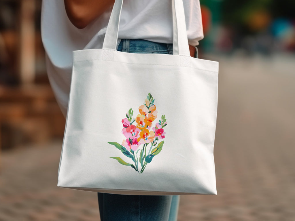 White tote bag with watercolor floral design of pink and orange flowers.