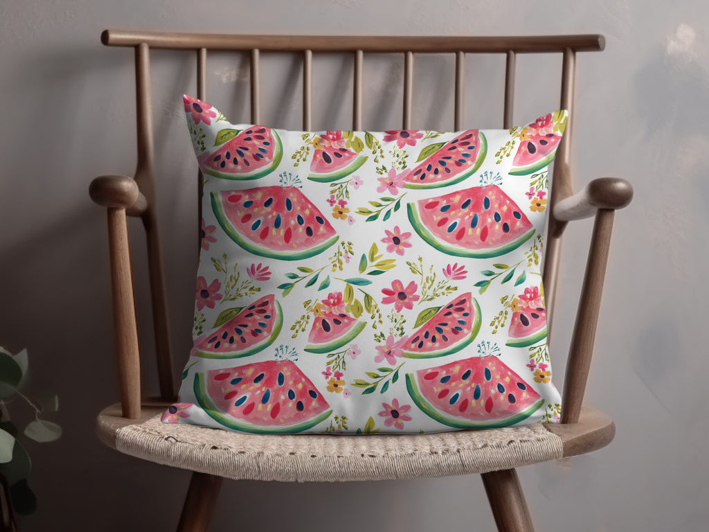 Decorative throw pillow with watermelon slices and pink floral pattern.