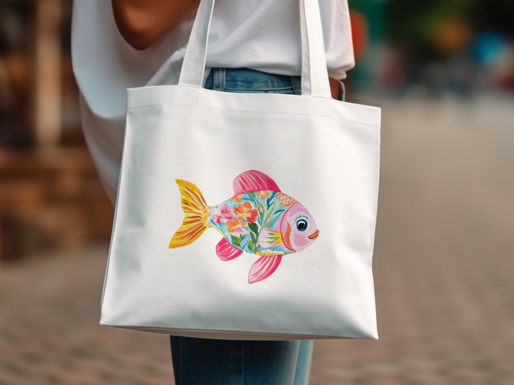 White tote bag featuring a colorful floral fish illustration.