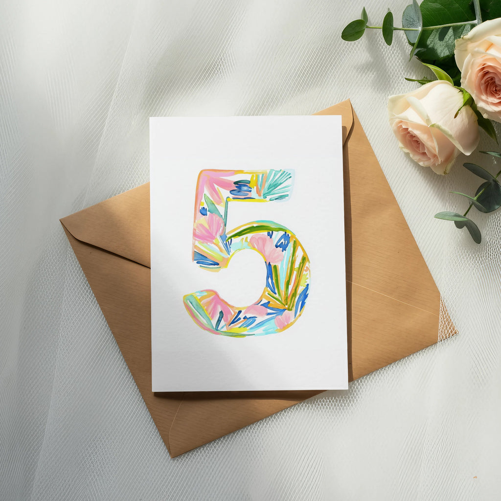 Card with watercolor number five and floral design on brown envelope.