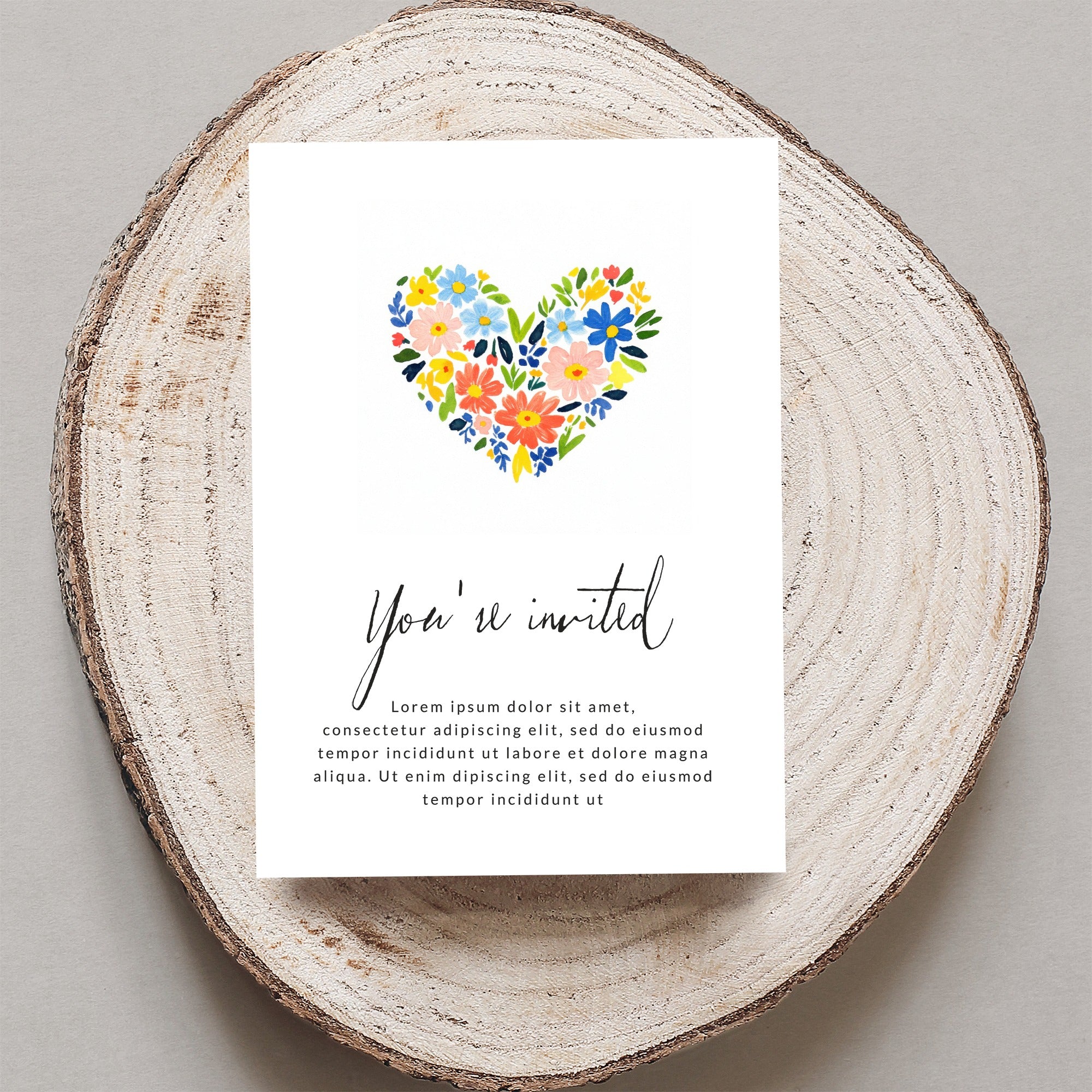 Invitation card with "You're invited" and floral heart design.
