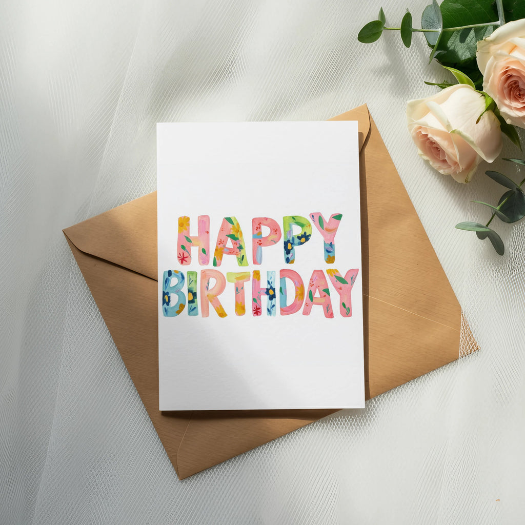 Birthday card with colorful "Happy Birthday" text on a brown envelope.