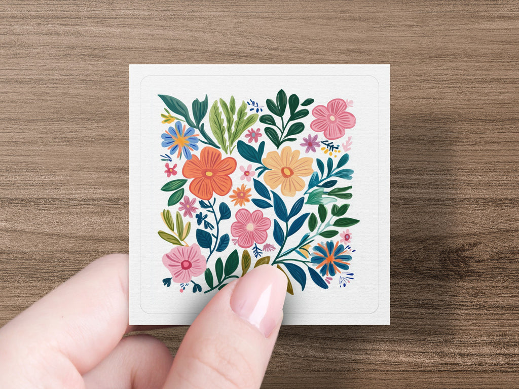 Floral pattern with pink, orange, and blue flowers and green leaves.