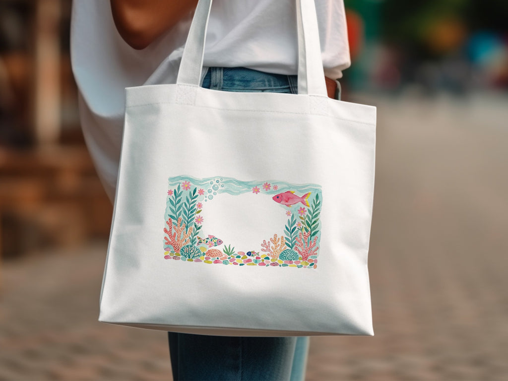 White tote bag with colorful coral, fish, and sea turtle illustration.