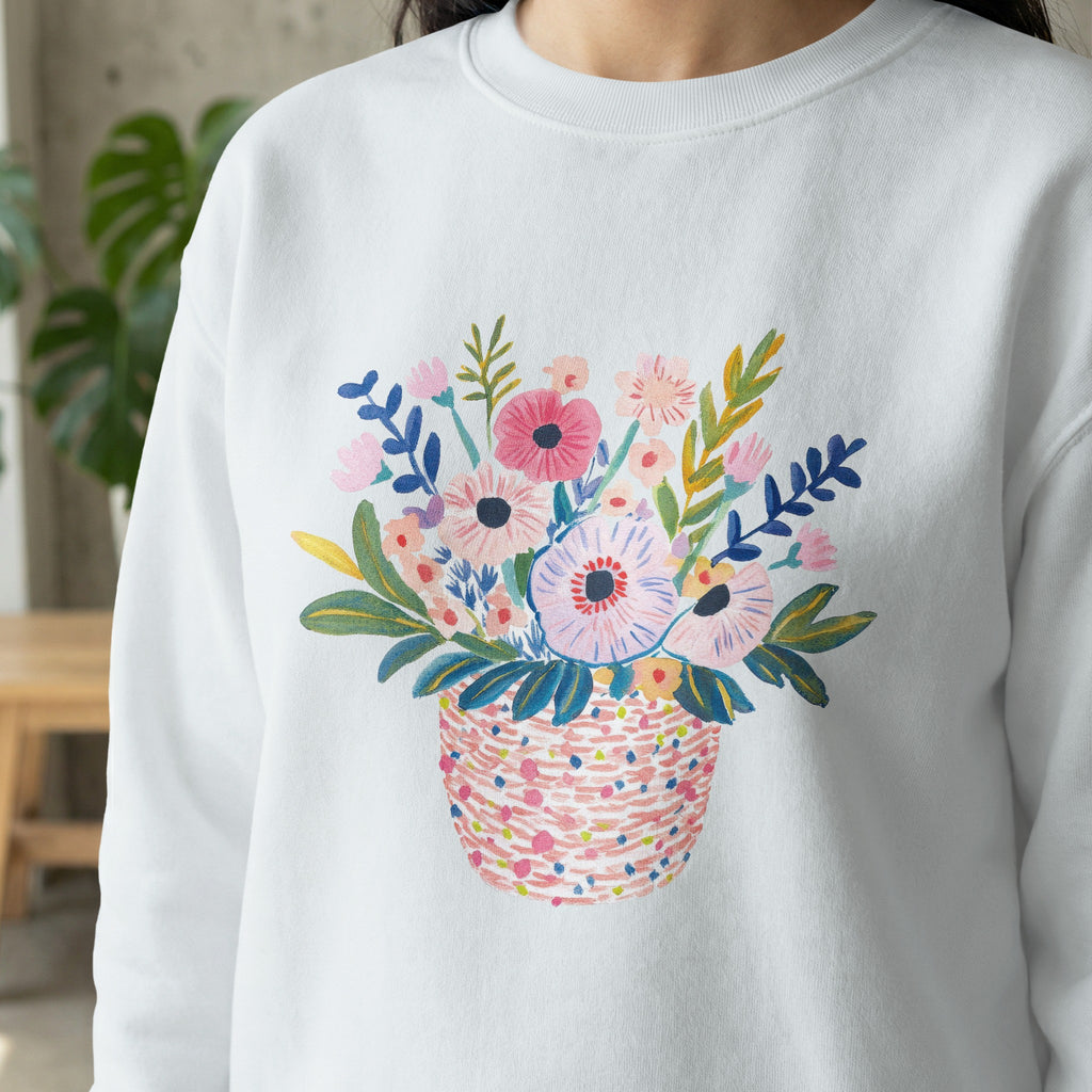 White sweatshirt with a colorful watercolor floral basket print.
