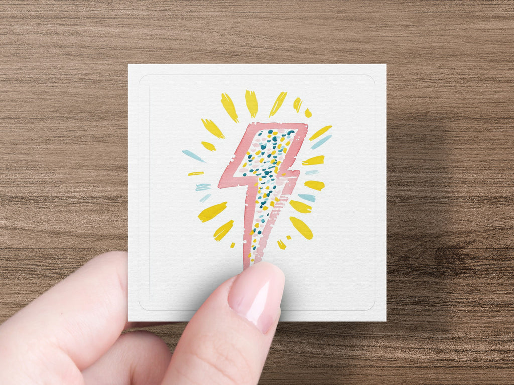 Pink and blue speckled lightning bolt with yellow rays.