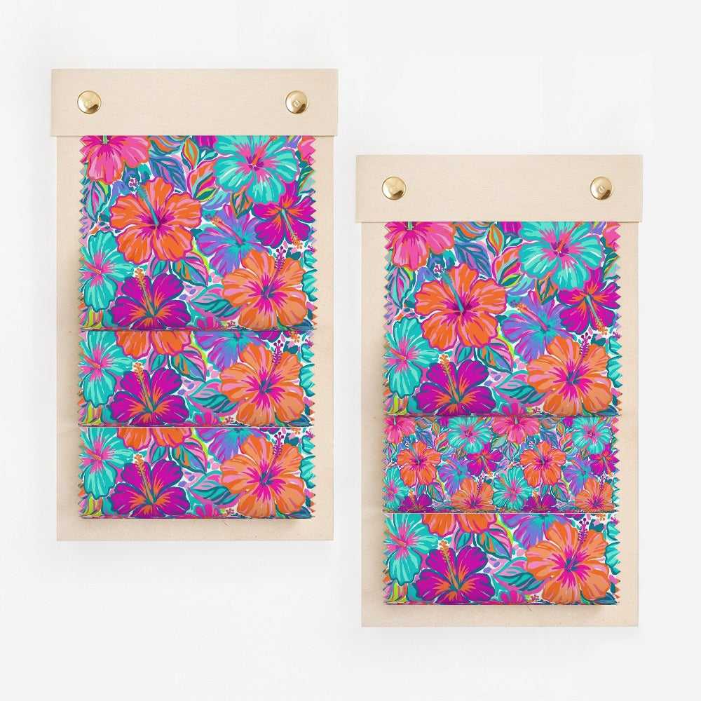 Two fabric swatches with vibrant hibiscus floral patterns.