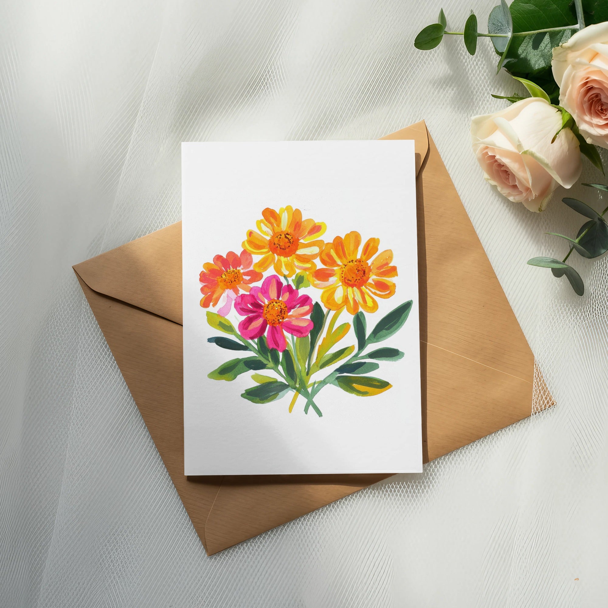 Watercolor painting of bright orange, yellow, and pink flowers on a white card atop a brown envelope.