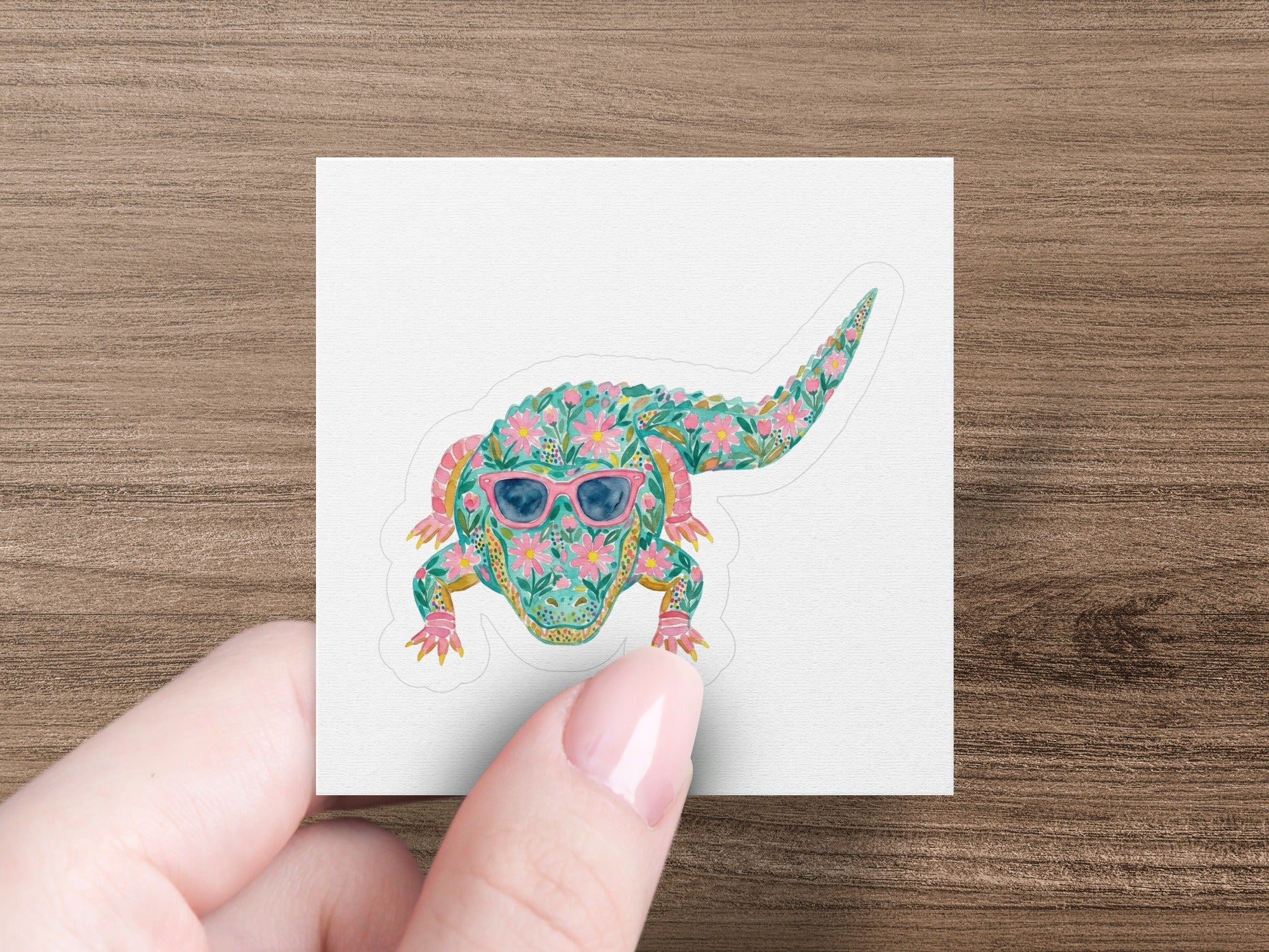Alligator sticker with floral pattern and pink sunglasses.