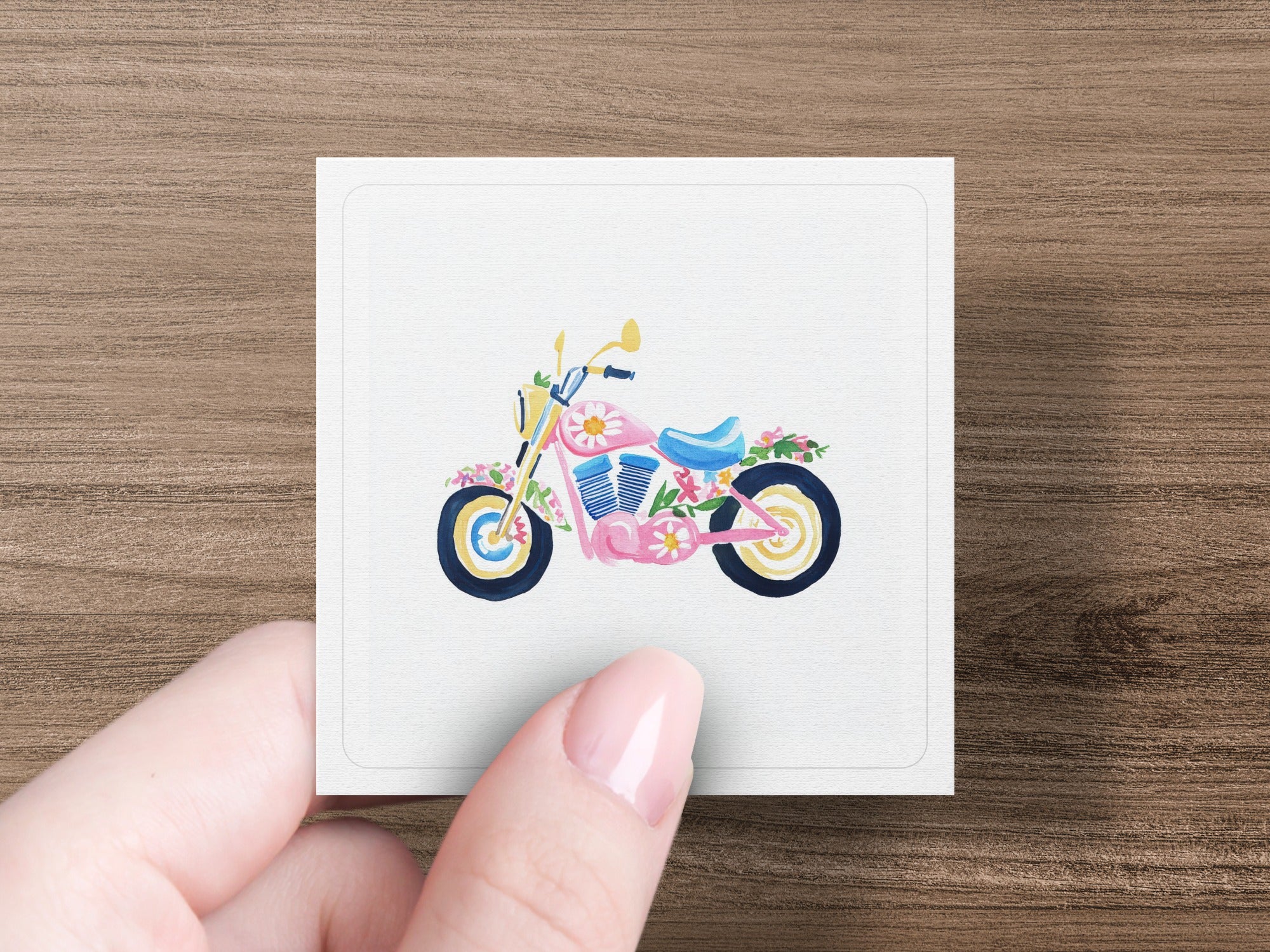 Watercolor illustration of a pink motorcycle adorned with flowers.