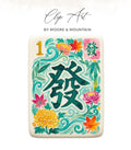 Mahjong tile with "發" (fa) character surrounded by floral and leaf motifs.