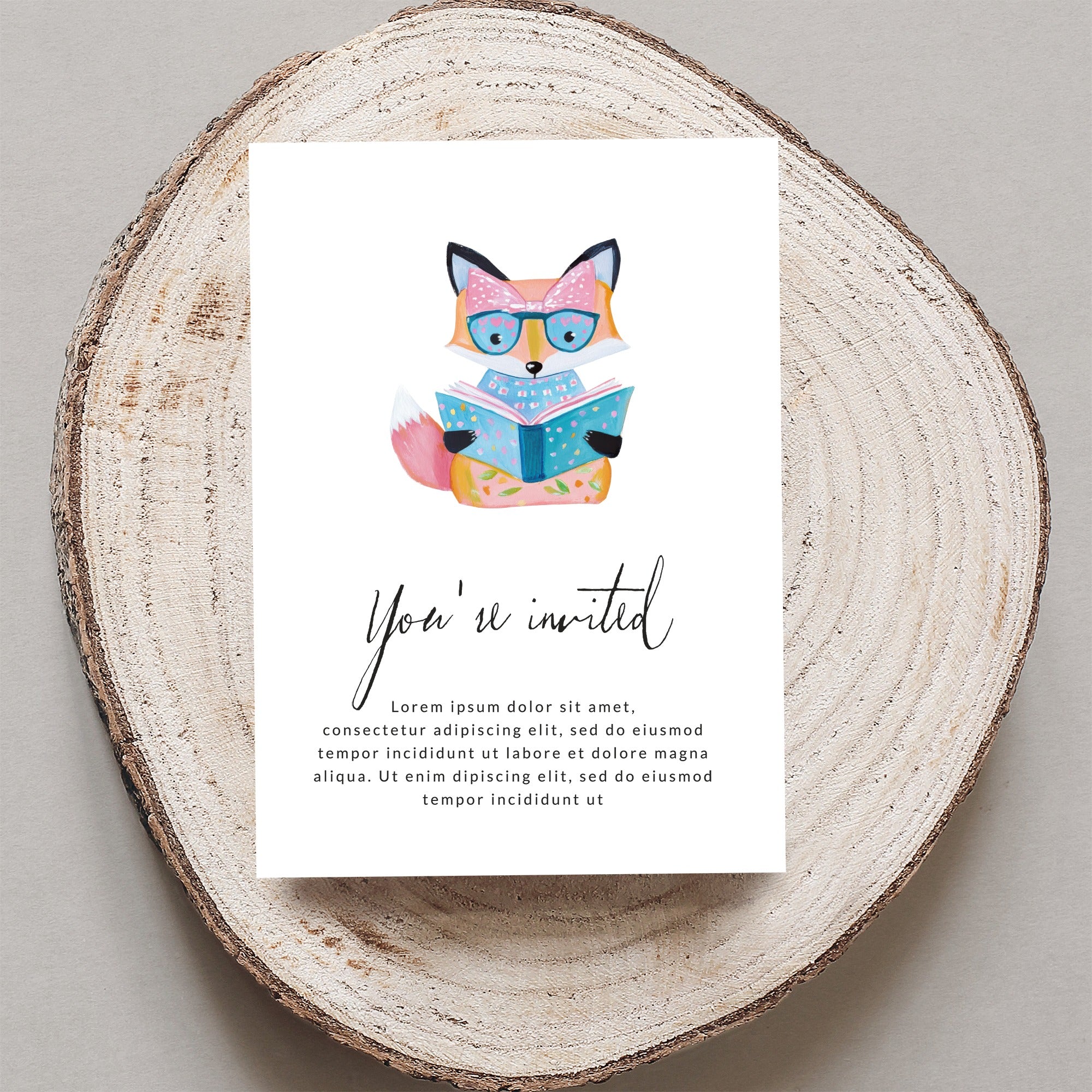 Fox wearing glasses reads a book on a "You're invited" card.