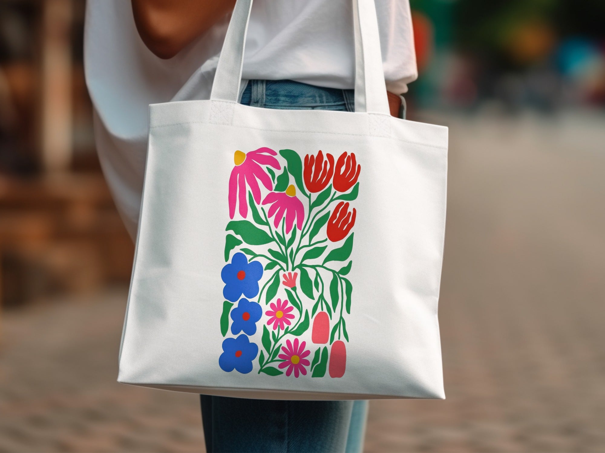 White tote bag with colorful floral folk art pattern.