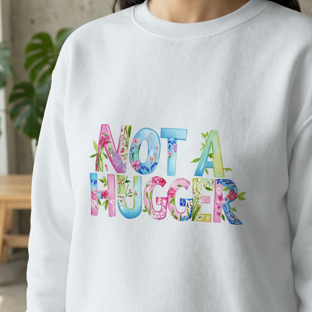 White sweatshirt with colorful floral "NOT A HUGGER" text.