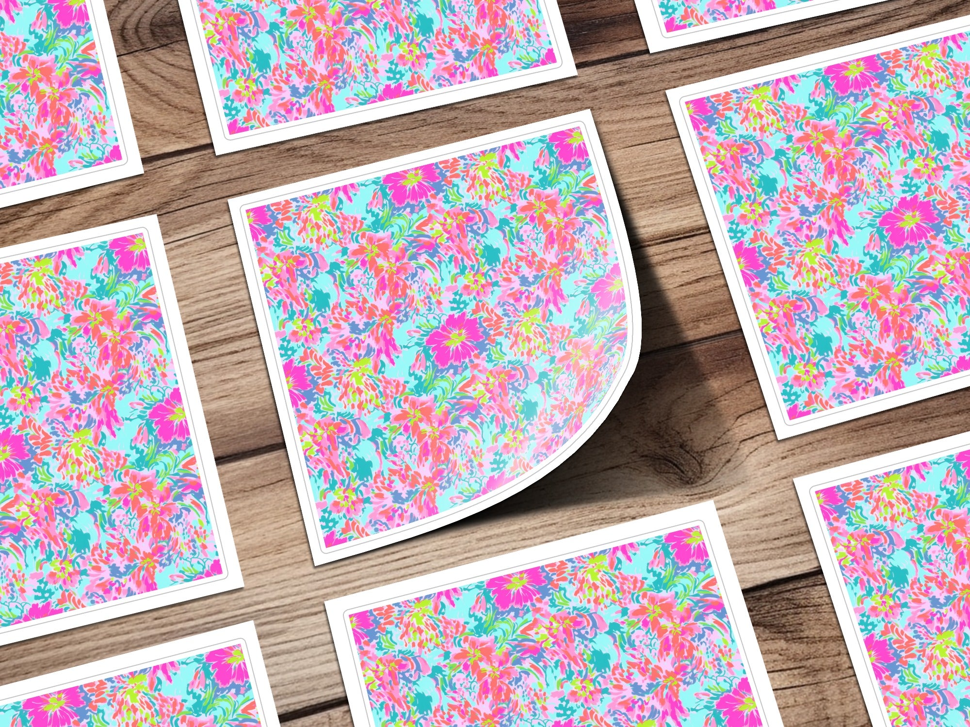 Floral pattern cards with pink, blue, and green flowers on a wooden surface.