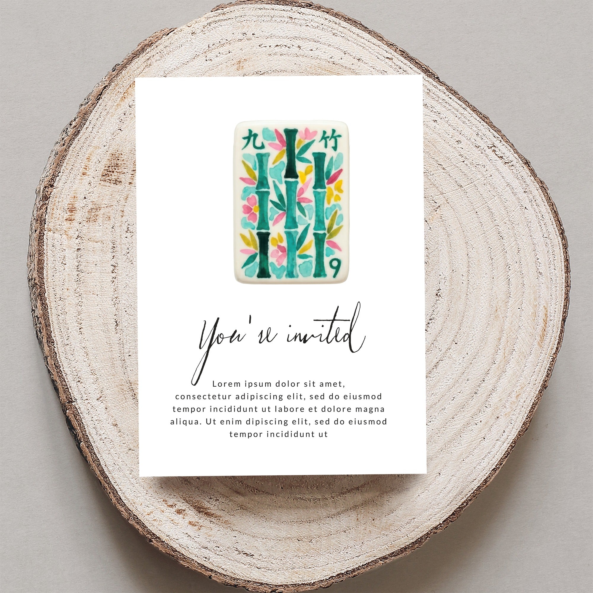 Invitation card with bamboo design and "You're invited" text.