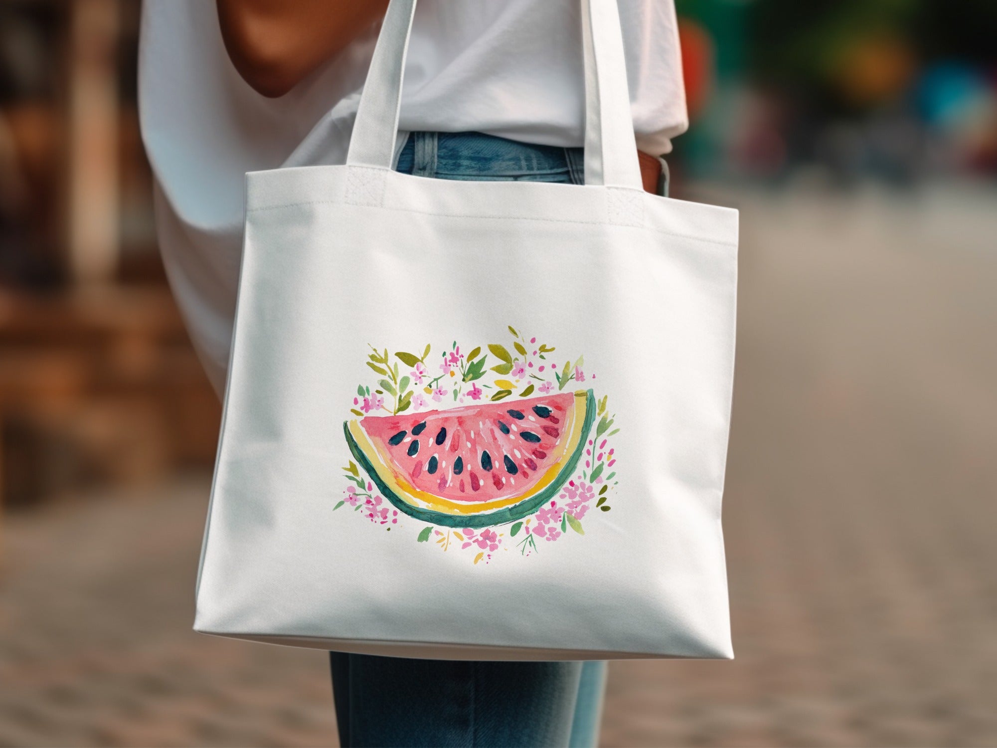 White tote bag with watercolor watermelon slice and floral design.