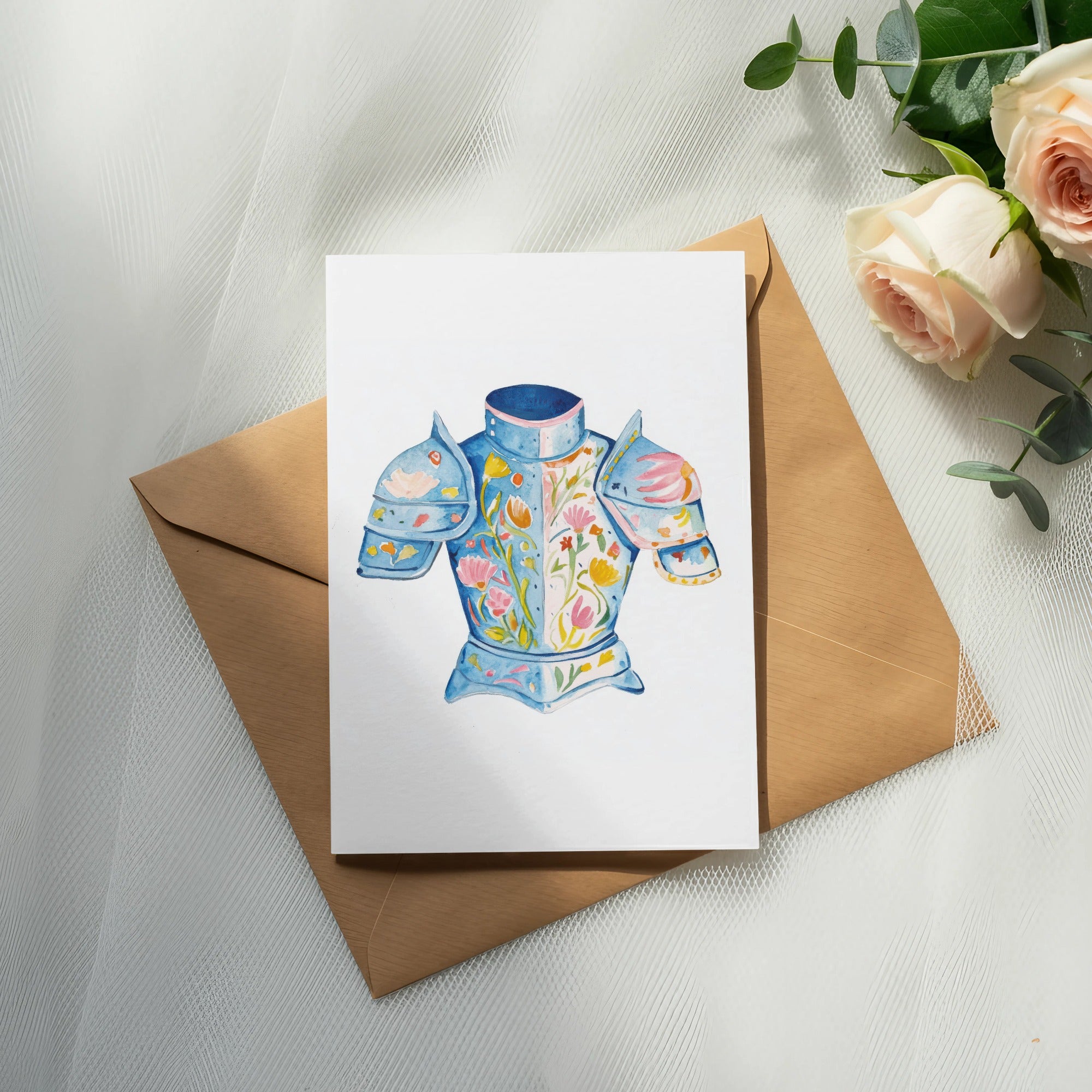 Watercolor illustration of a blue floral-decorated knight's breastplate on a card.