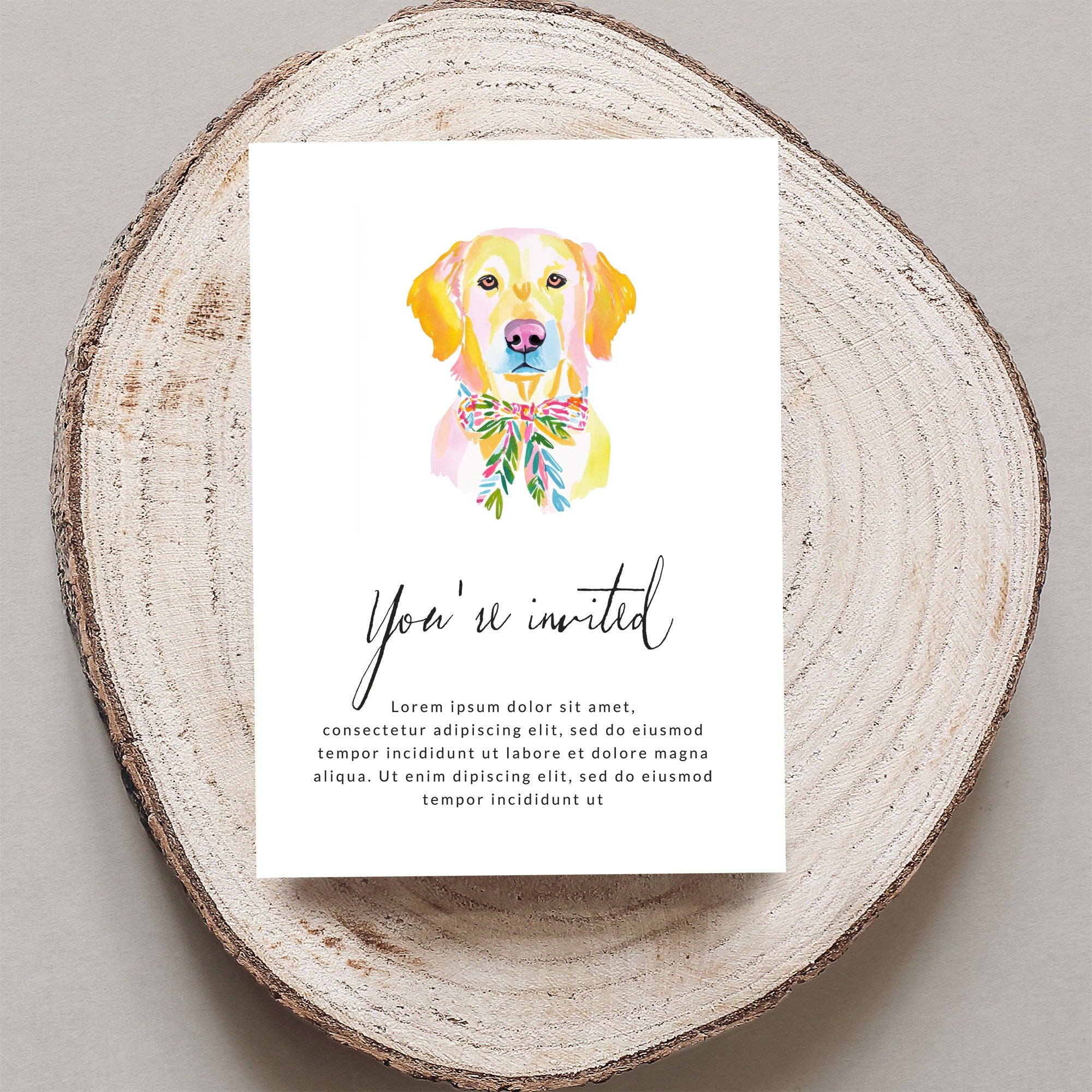 Invitation with watercolor dog wearing a floral bow and "You're invited" text.