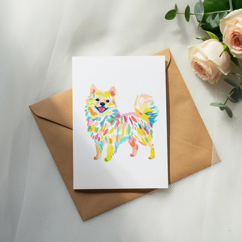 Colorful watercolor Pomeranian dog illustration on a card with envelope and roses.