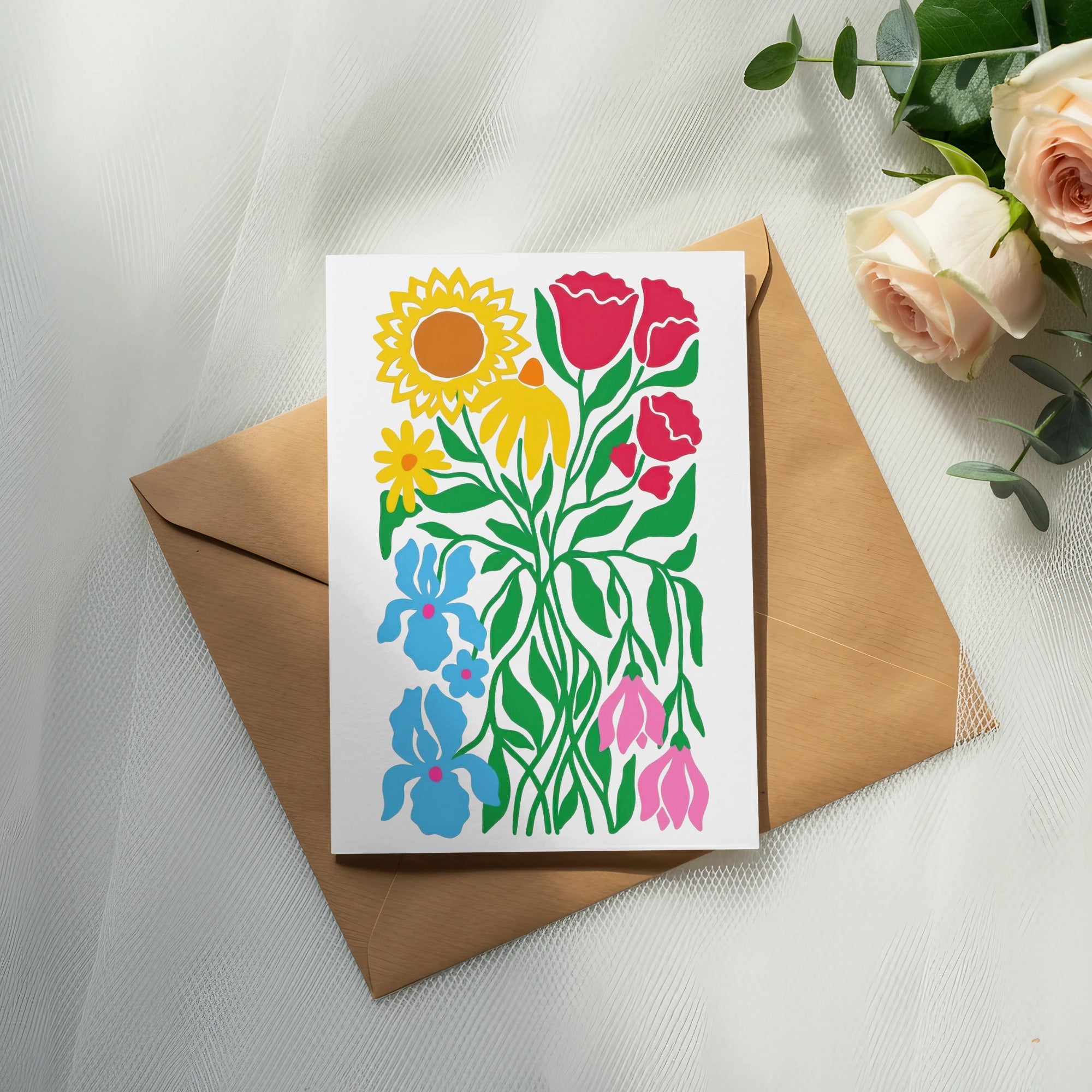 Card with colorful floral illustration on brown envelope, with roses and eucalyptus.