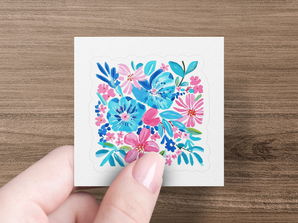 Floral sticker with pink and blue flowers on white square.