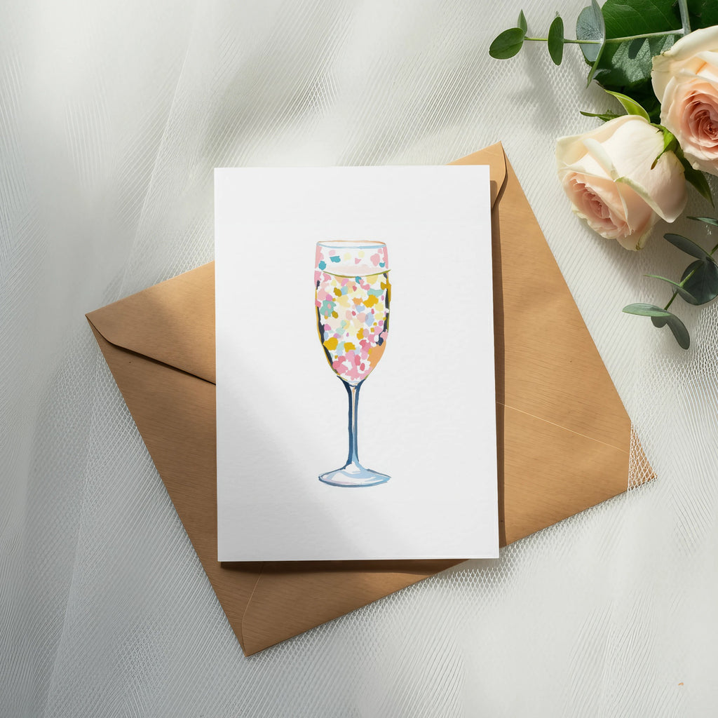 Card with champagne flute illustration on an envelope, with roses and eucalyptus.