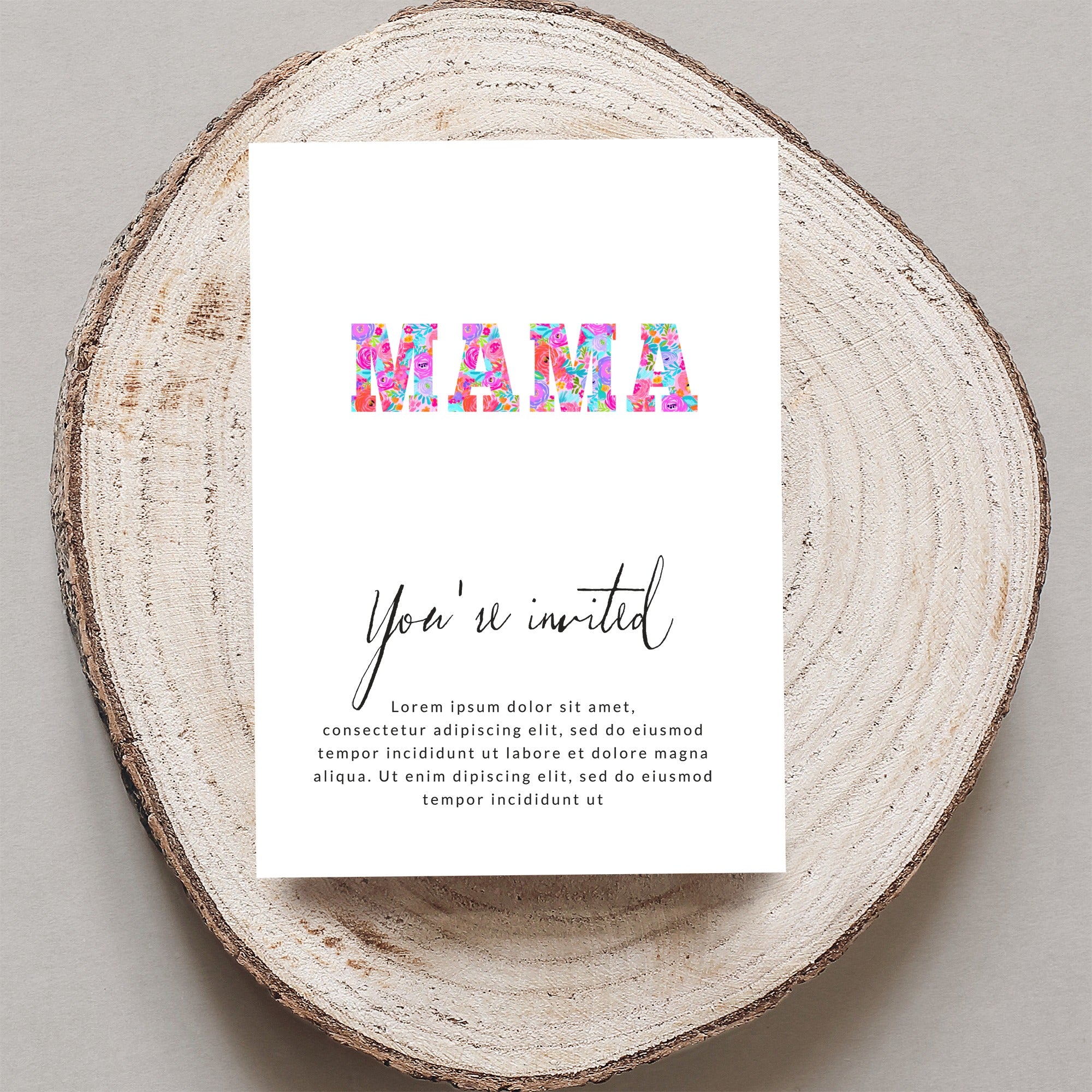 Floral "MAMA" invites with placeholder text on a wood slice.